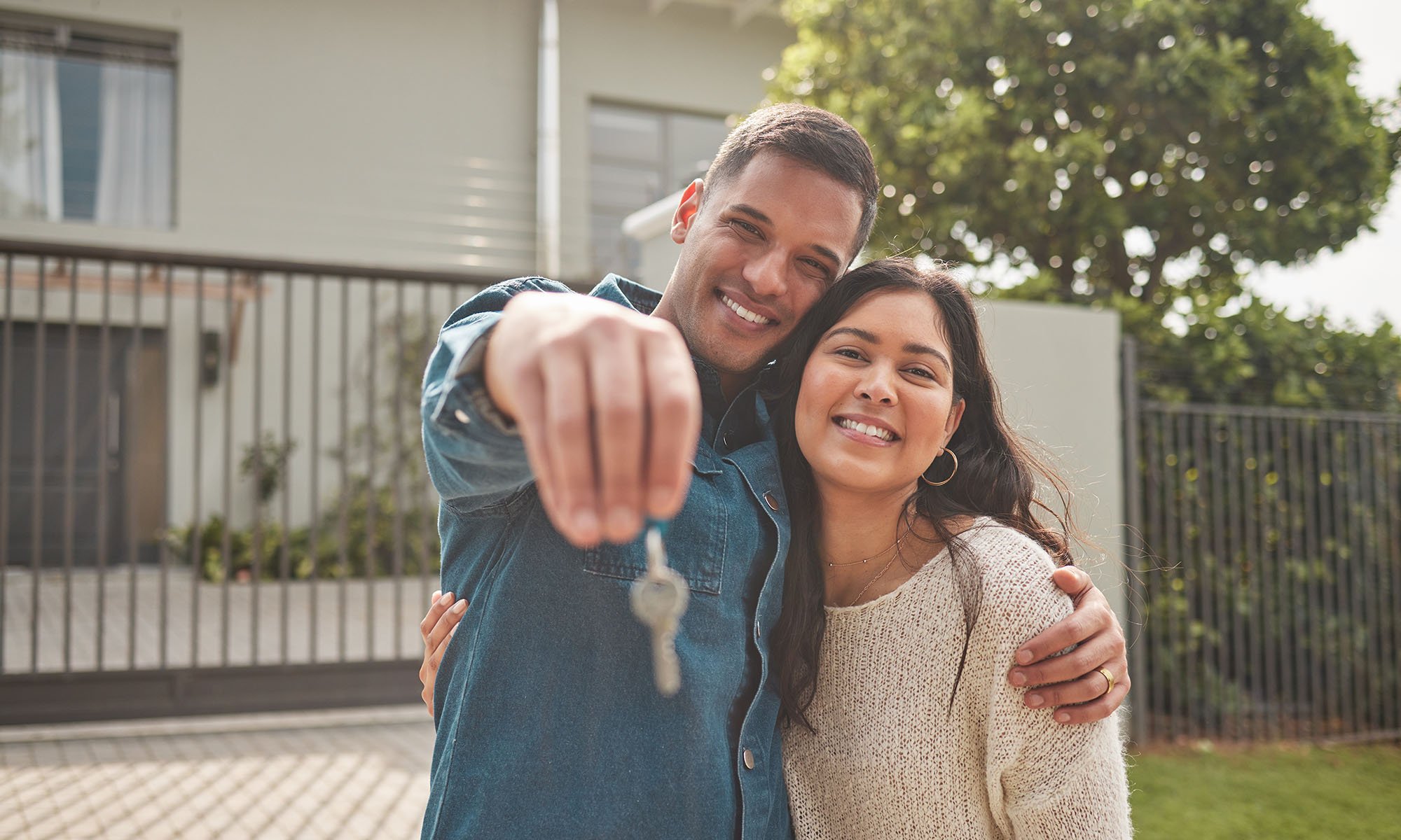 couple holding keys to new home