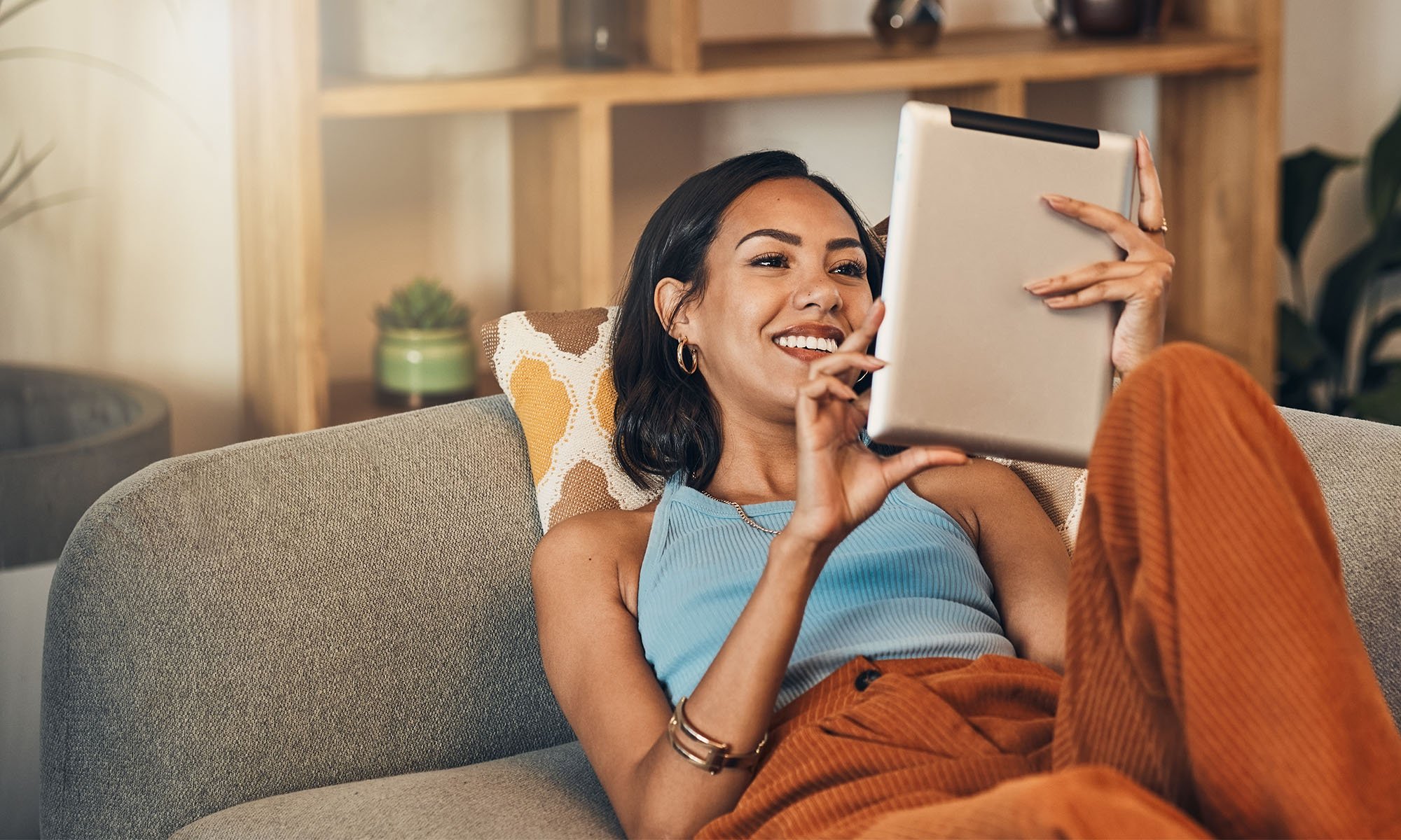 woman on tablet relaxing on