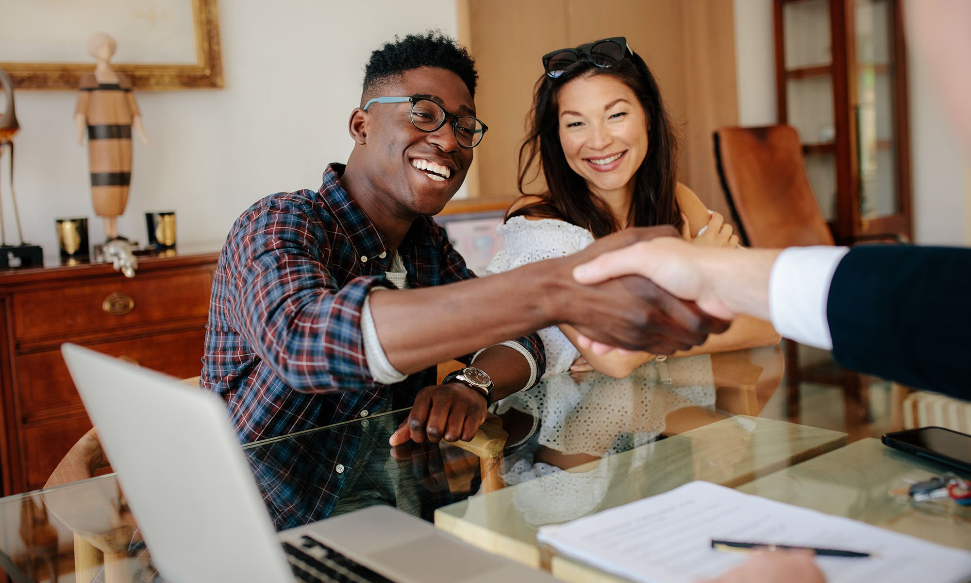 happy couple shaking hans with loa